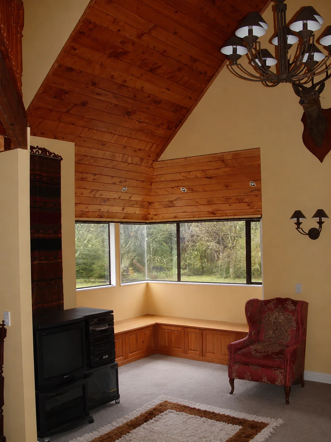 House Additions interior with timber-lined ceiling and window seat